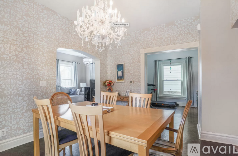 A dining room with a wooden table and chairs.
