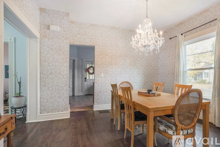 A dining room with a wooden table and chairs.