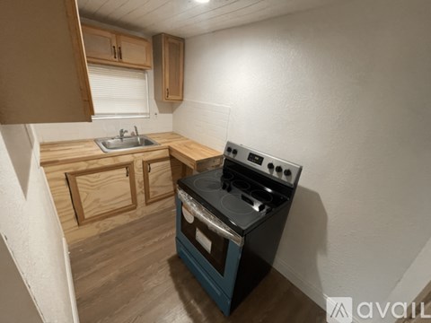 A small kitchen with a stove and sink.