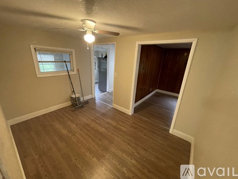 A room with a window and a vacuum cleaner.