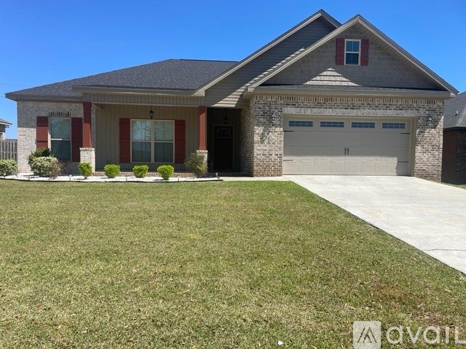 A house with a garage and a driveway in front.