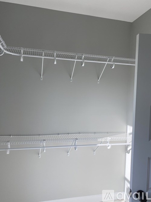 A wall of empty shelves in a room.