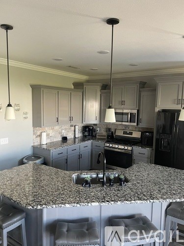 A kitchen with granite countertops and stainless steel appliances.