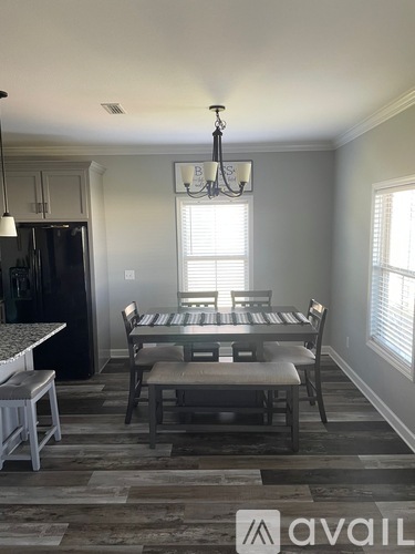 A dining room with a table set for four.
