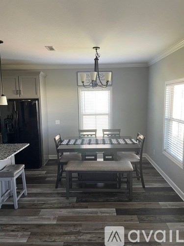 A dining room with a table set for four.