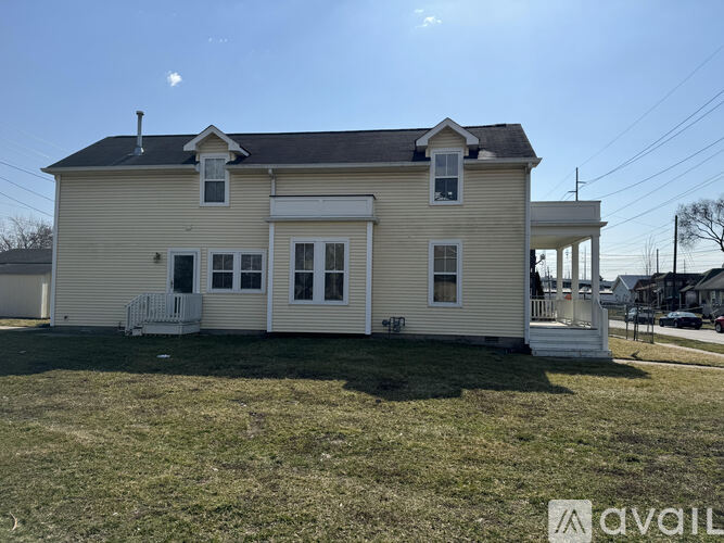 A two-story house with a white front porch.