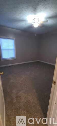 A room with a window and a ceiling light.