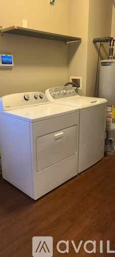 A white dishwasher with a digital display on the wall.