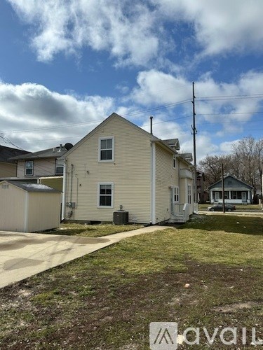 A house with a white exterior and a driveway in front.