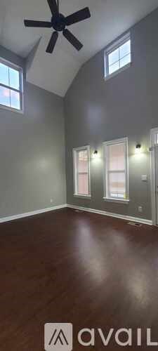 A room with a ceiling fan and a window.
