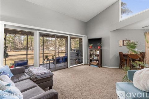 A living room with a grey couch and a blue chair.