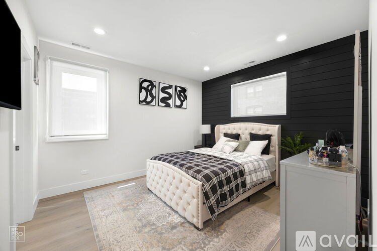 A bedroom with a large bed and a window.