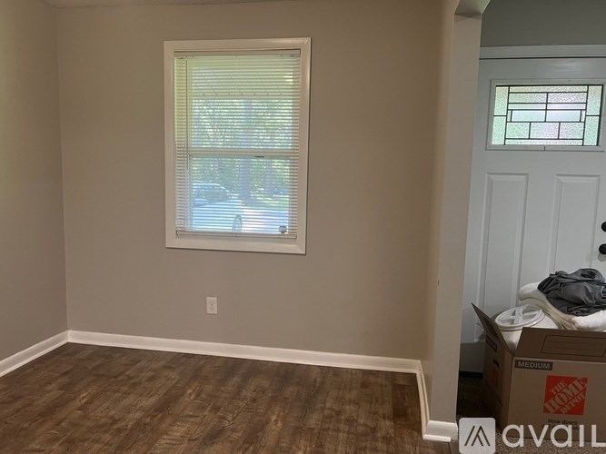 A room with a window and a door.