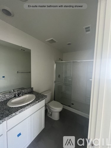 A bathroom with a sink, toilet, and shower.
