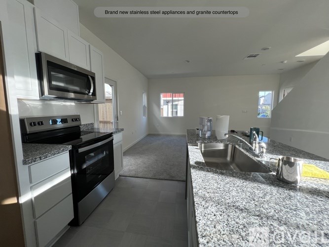 A kitchen with stainless steel appliances and granite countertops.