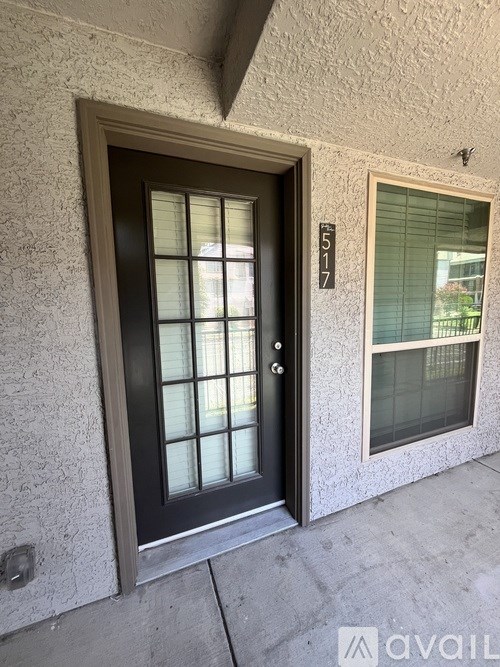 A black door with a glass panel and a number 517 on the wall.