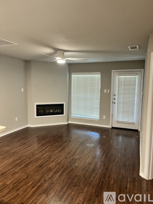 A room with wooden floors and a fireplace.