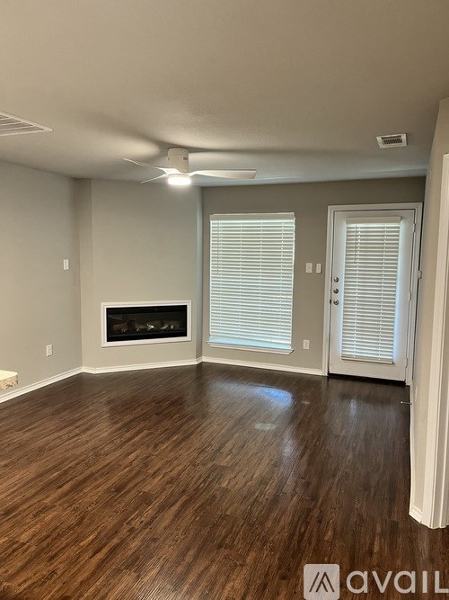 A room with wooden floors and a fireplace.