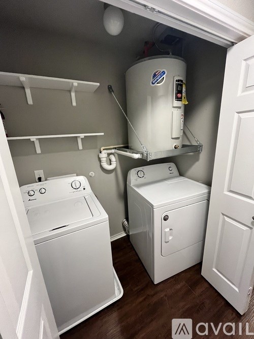A small laundry room with a washer and dryer.