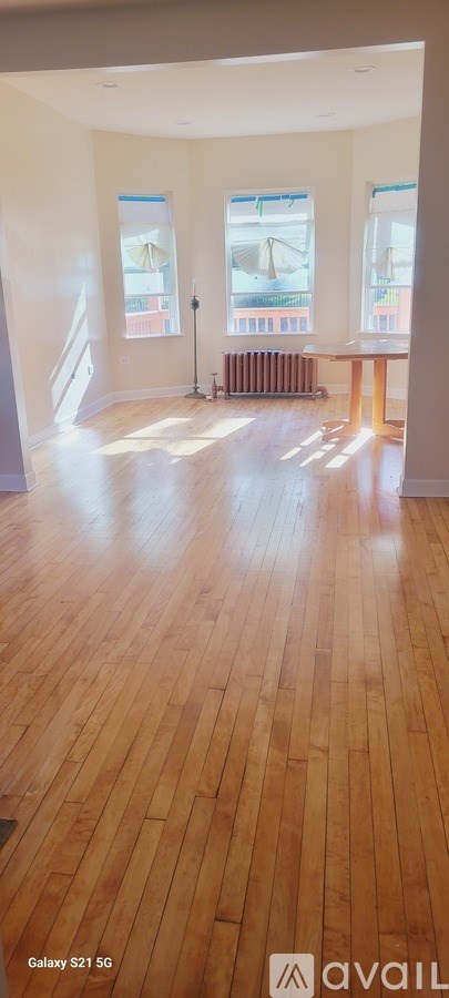 A room with wooden floors and a window.