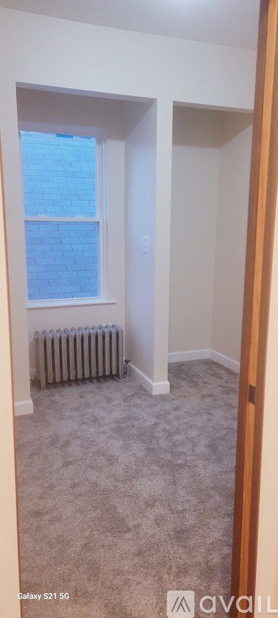 A room with a window and a radiator.