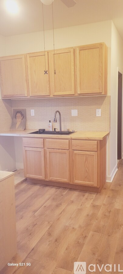 A kitchen with wooden cabinets and a tiled backsplash.