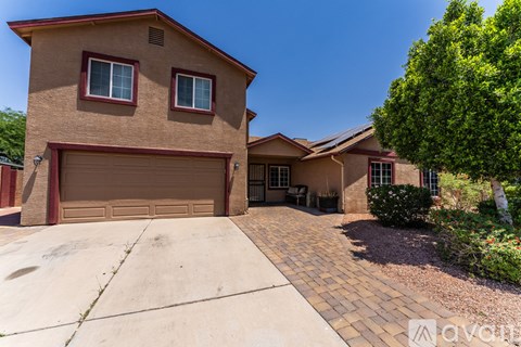 A house with a brown garage door and a driveway.