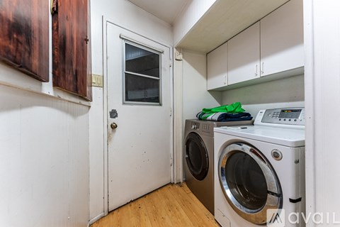 A small laundry room with a washer and dryer.