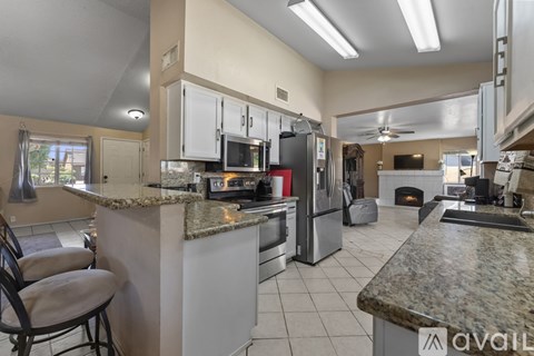 A kitchen with granite countertops and stainless steel appliances.