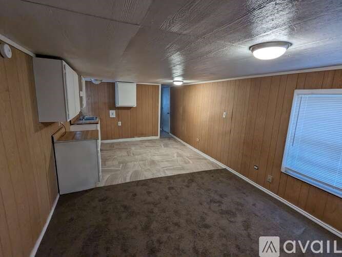 A room with wooden walls and a carpeted floor.