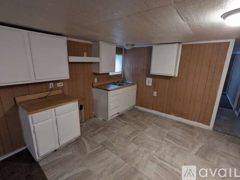 A kitchen area with wooden cabinets and a countertop.