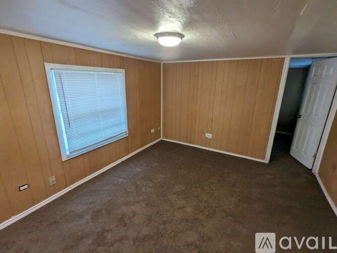 A room with wooden walls and carpeted floor.