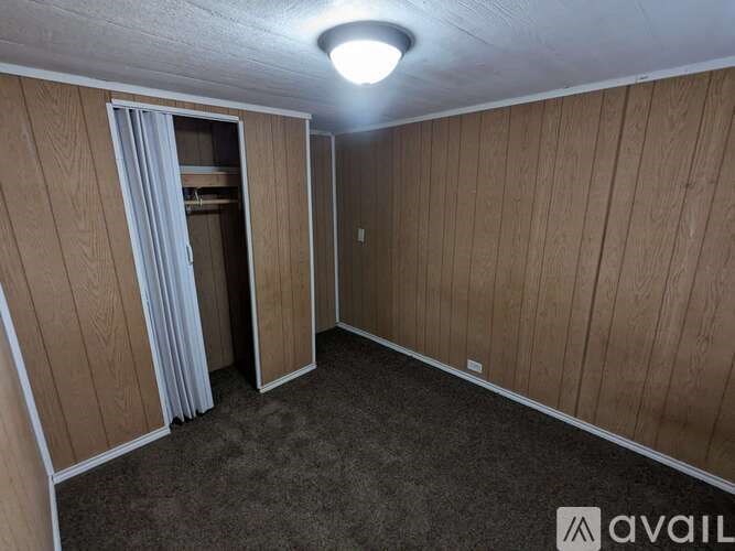 A room with wooden walls and a carpeted floor.