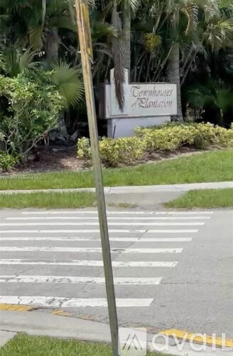 A sign for the Townhouses of Radiant is in front of a crosswalk.