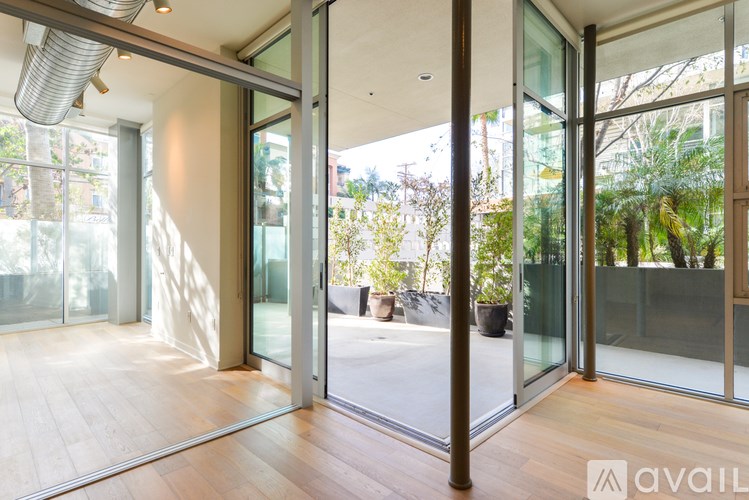A modern interior space with glass doors and wooden floors.