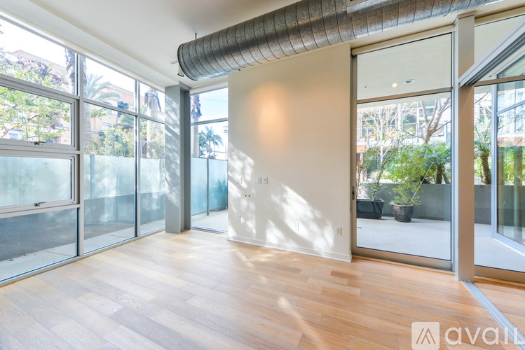 A room with wooden floors and a large window.