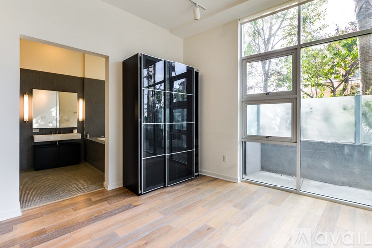A room with a black cabinet and a glass door.