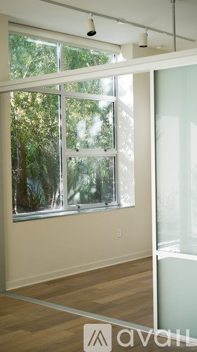 A room with a window and a sliding glass door.