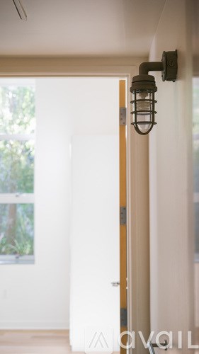 A white door with a light on the side.