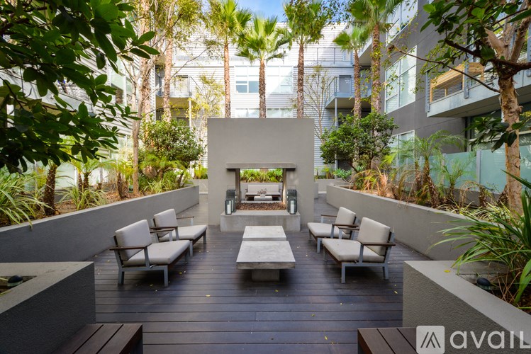A patio with a table and chairs surrounded by trees.