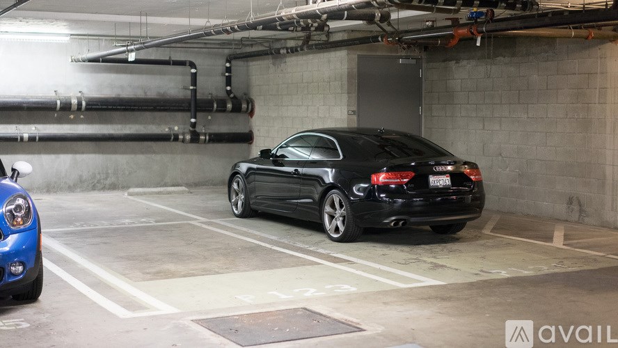 A black car is parked in a garage.