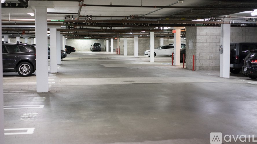 A spacious parking garage with multiple cars parked.