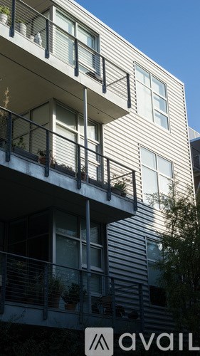 A building with balconies and a sign that says "available".