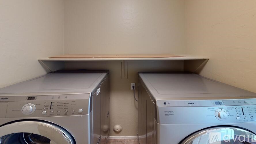 Two washing machines in a small laundry room.