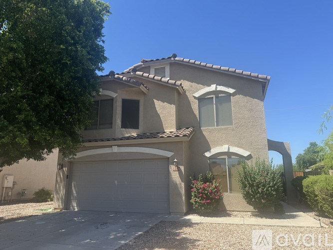 A house with a garage is for sale.