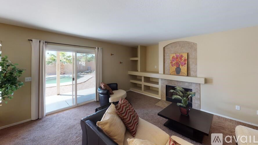 A living room with a couch, coffee table, and fireplace.