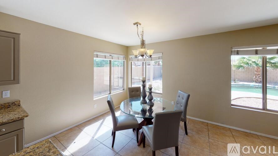 A dining room with a table set for four.