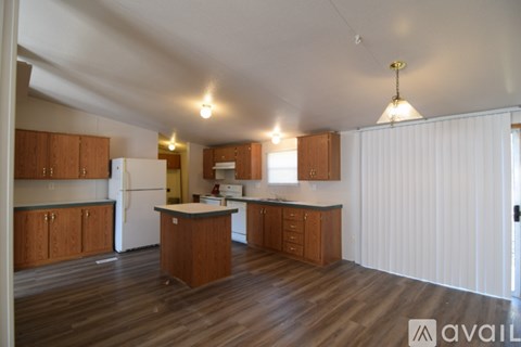 A kitchen with wooden cabinets and a white refrigerator.