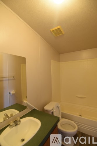 A bathroom with a toilet, sink, and bathtub.