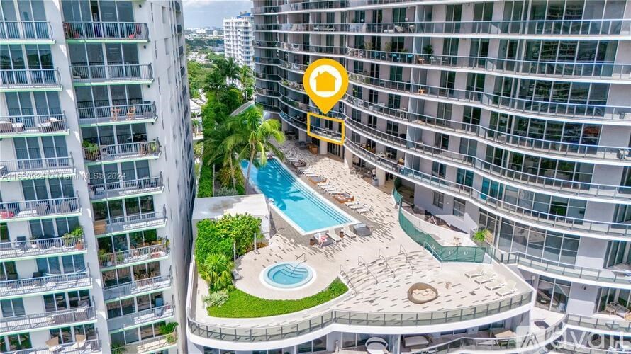 A pool area in a residential building with a yellow pin on the balcony of a unit.